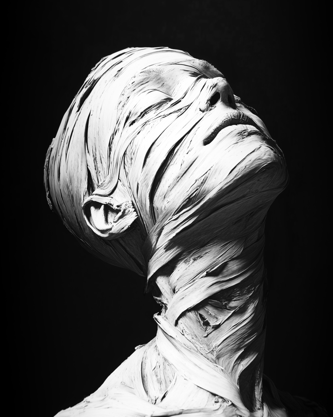 Sculpture of a mummy head; horror-inspired; black and white